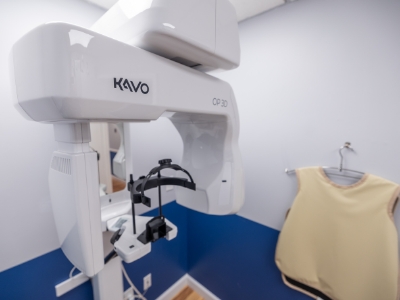 C T cone beam scanning machine standing against white wall