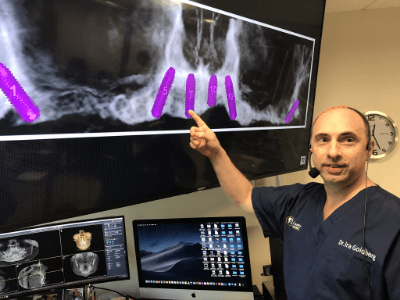 Dr Goldberg at a seminar presenting on a monitor