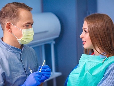 Dentist discussing how a smile makeover works with patient