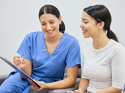 Dental staff member discussing payment with patient