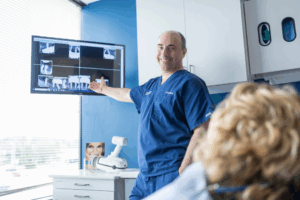 a close-up of Dr. Goldberg smiling and helping a patient