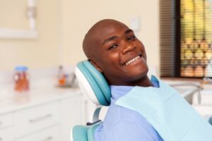Man smiling confidently after visiting his dentist
