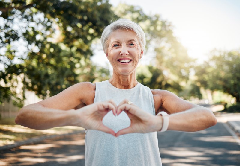 Lady makes heart symbol with hands